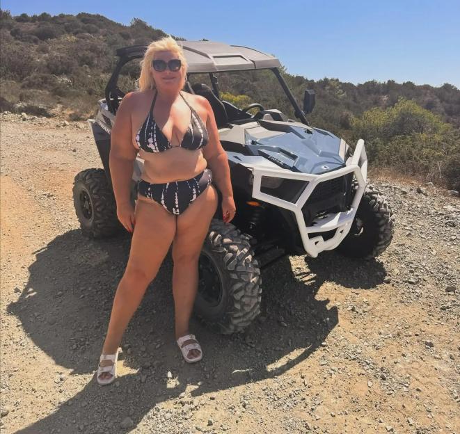Gemma Collins poses in a bikini next to an ATV.
