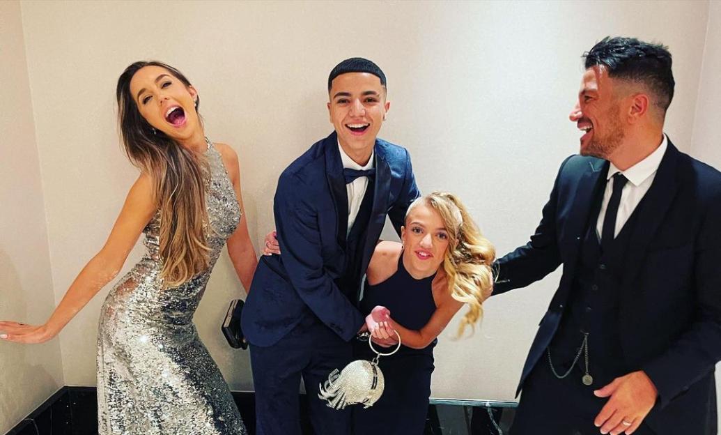 Peter and Emily Andre with Princess and Junior on a red carpet.