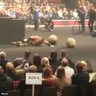 Strongman lying on the ground after falling during a competition.