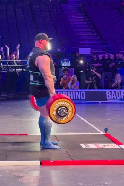 Strongman lifting a heavy barbell.