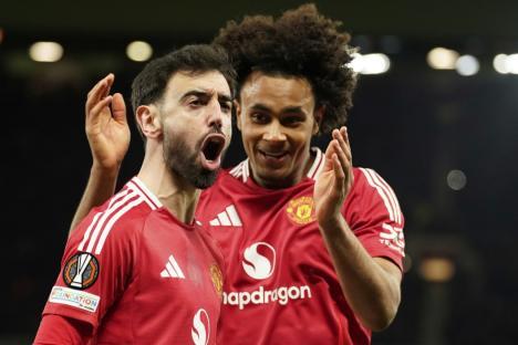 Manchester United's Bruno Fernandes left, and Manchester United's Joshua Zirkzee celebrate scoring their side's first goal during the Europa League soccer match between Manchester United and Real Sociedad at Old Trafford stadium in Manchester, England, Thursday, March 13, 2025 . (AP Photo/Dave Thompson)