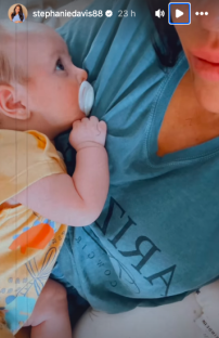Video of a baby with a pacifier resting on its mother's chest.