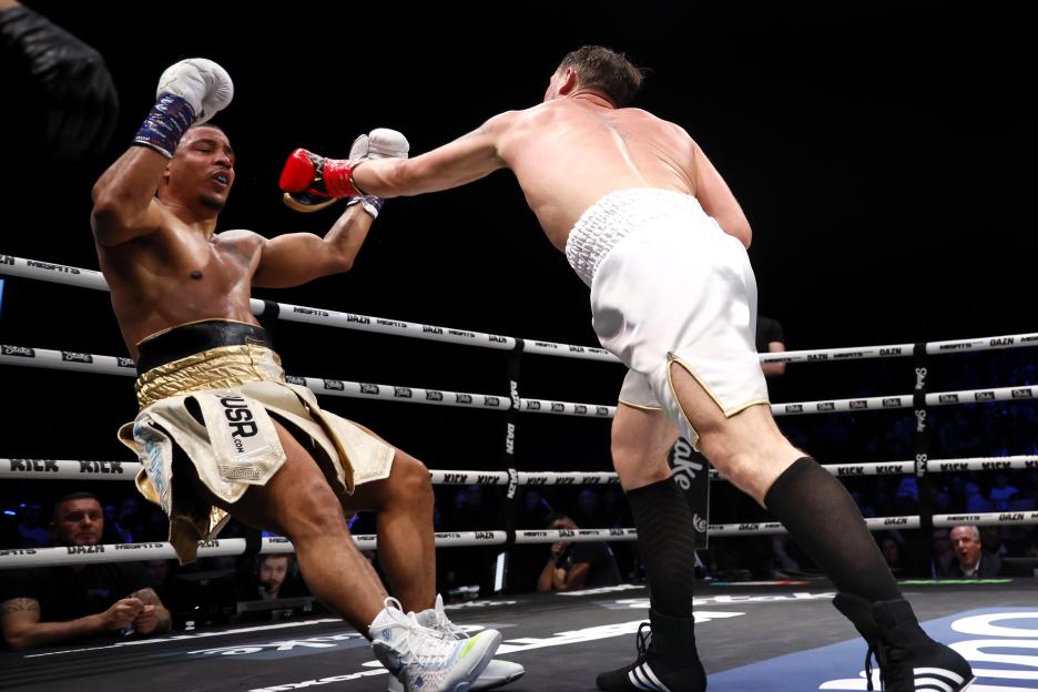Darren Till (right) throwing a punch at Anthony Taylor during a heavyweight boxing match.