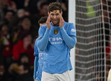 Manchester City's John Stones looking dejected during a soccer match.