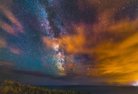 Milky Way galaxy over the ocean at night.