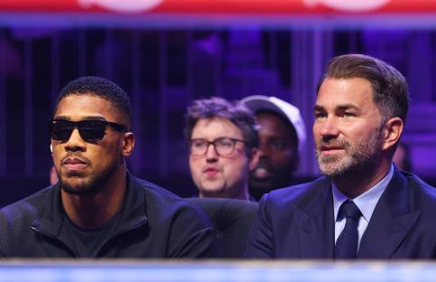 Anthony Joshua and Eddie Hearn ringside at a boxing match.
