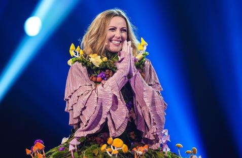 a woman in a purple dress with flowers on it