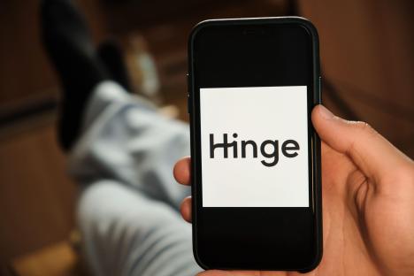 Smartphone displaying the Hinge dating app logo.