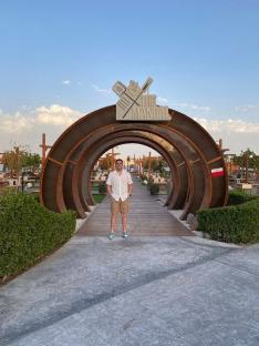 Man standing in front of The Mangal restaurant entrance.