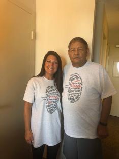 Photo of a man and woman wearing matching kidney transplant awareness t-shirts.