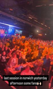 A large crowd of cheering fans at an event.