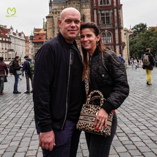 Couple posing in a European city square.