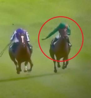 Jockey falling off horse during a race.
