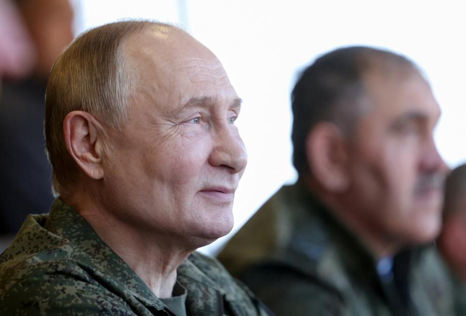 Putin dons military fatigues in war games 500 miles from the frontline in a show of strength to the West