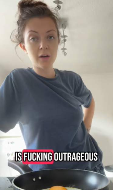 Woman cooking an egg while saying "is fucking outrageous" in a video still.