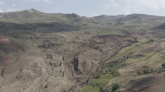 Aerial view of a mountainous landscape with erosion.