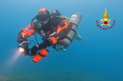 Diver recovering a body from a shipwreck.