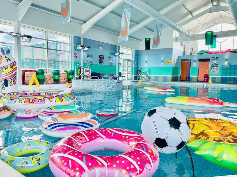Indoor pool with inflatable toys.