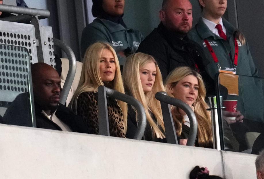 Claudia Schiffer and her daughters watching a soccer match.