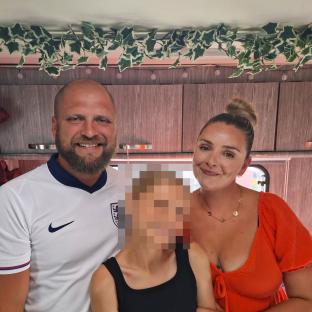 Family portrait of a man, woman, and child.
