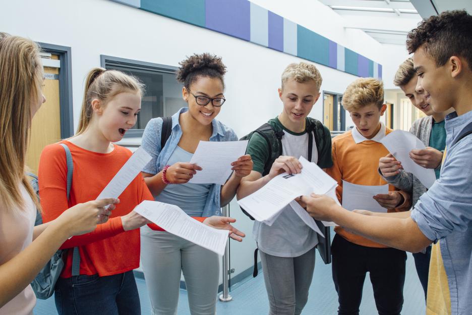 Happy high school students celebrating their exam results.
