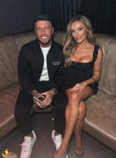 Adam and Amy sitting together on a couch.