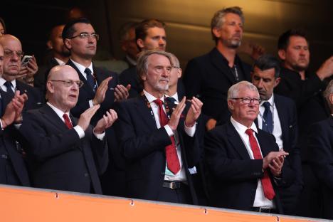 Avram Glazer, co-owner of Manchester United, and others applauding in the stands.