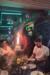 Bruno Fernandes and Joao Cancelo at a birthday dinner with a sparkler cake.