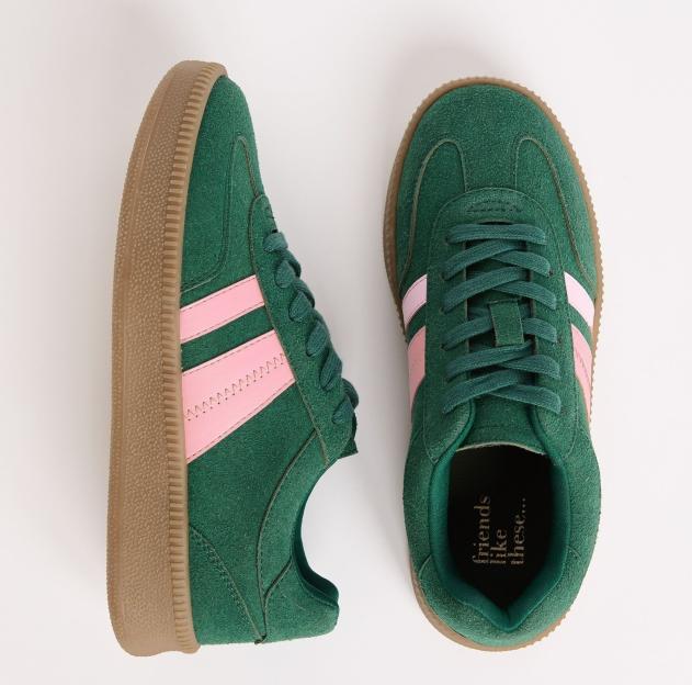 Pair of green suede sneakers with pink stripes.