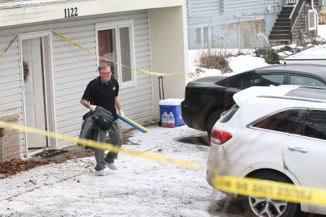 Crime scene reconstruction specialist leaving a crime scene.