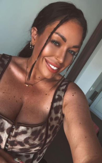 Selfie of a woman wearing a leopard-print top.