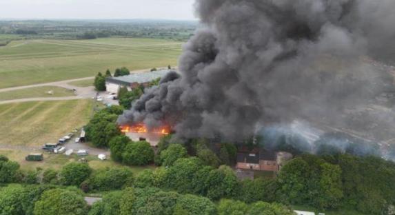 Aerial view of a large fire with heavy smoke.