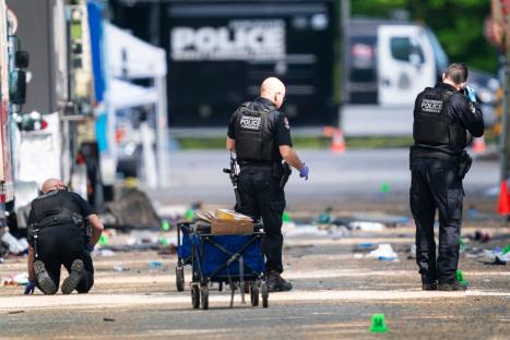 Vancouver Police forensics officers examining evidence at a street festival scene.
