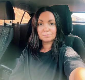 Woman in a car taking a selfie.