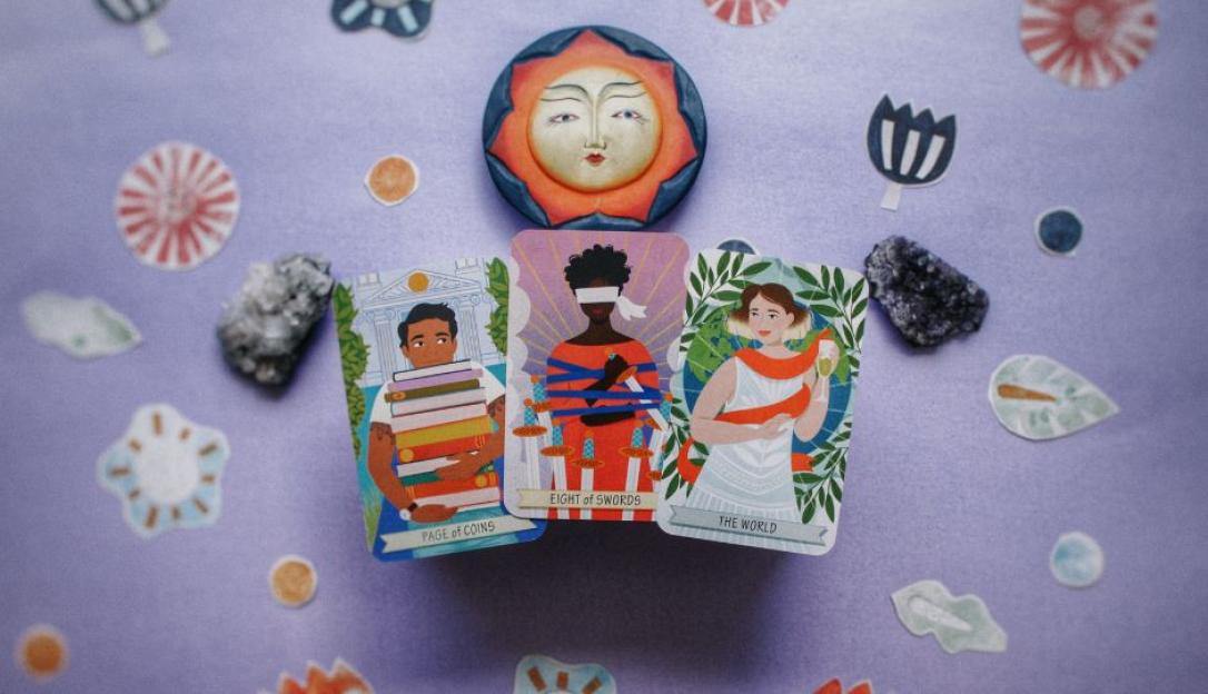 Illustration of three tarot cards: Page of Coins, Eight of Swords, and The World, arranged on a purple surface with decorative elements.