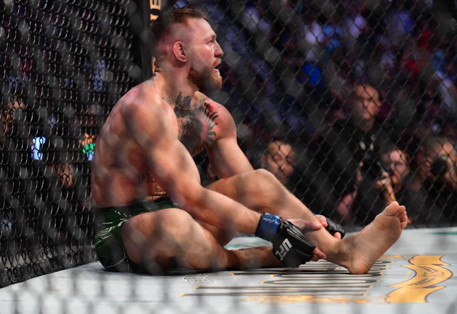 Conor McGregor reacting to an injury during a UFC match.