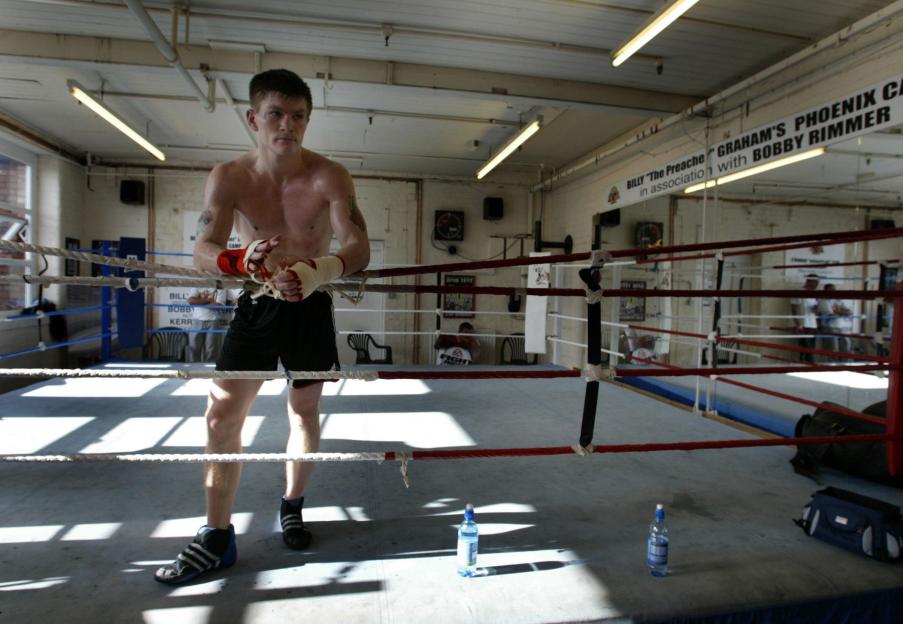 Boxer Ricky Hatton wrapping his hands in a gym.