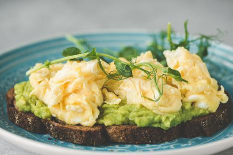 Toast with mashed avocado and scrambled eggs.