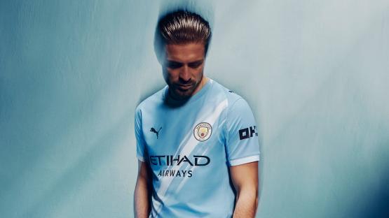 Man in Manchester City jersey.