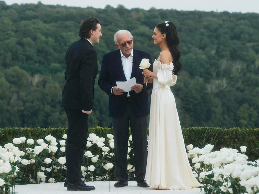 A wedding ceremony with the bride and groom exchanging vows.