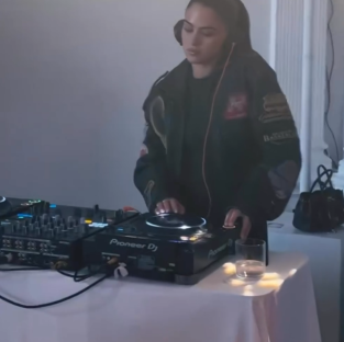 Woman DJing with Pioneer DJ equipment.