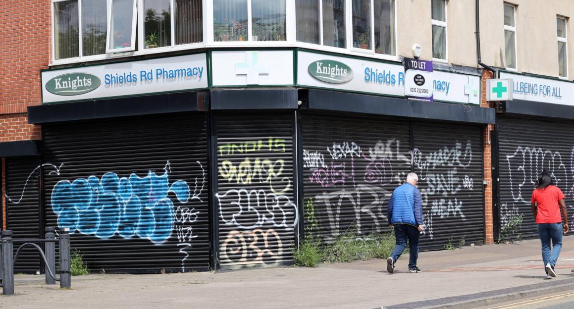 Graffiti-covered closed shops on Shields Road, Newcastle.