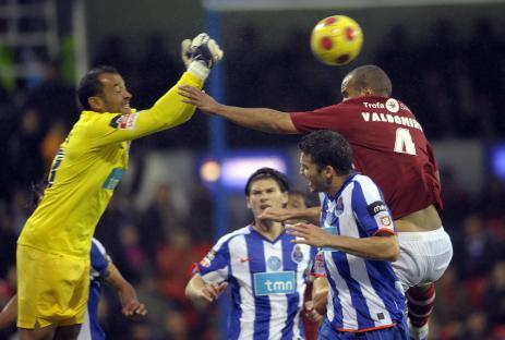 Soccer player heading the ball during a match.