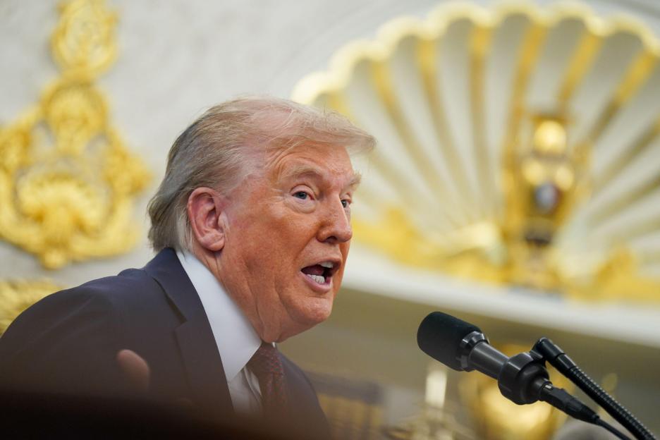 President Trump speaking at a podium in the Oval Office.