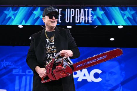 Elon Musk holding a chainsaw at CPAC.