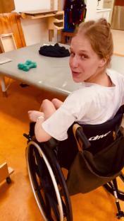 Woman in wheelchair looking over her shoulder.