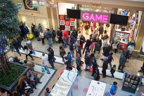 Game store in a shopping mall with many people waiting in line.