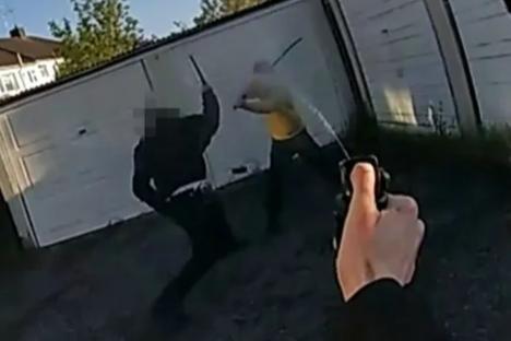 Horrifying moment ‘killer’ slashes cops with sword after he ‘knifed boy, 14, to death in ferocious rampage’