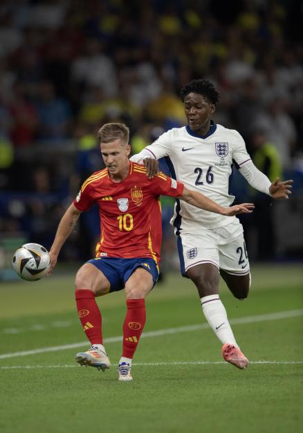 Spain's Dani Olmo and England's Kobbie Mainoo vying for the ball during a soccer match.