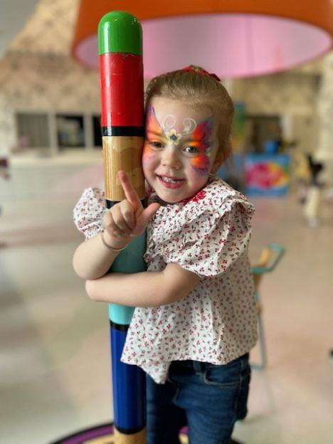 Girl with butterfly face paint.
